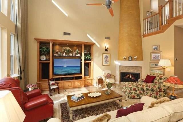 a living room with furniture fireplace and a window