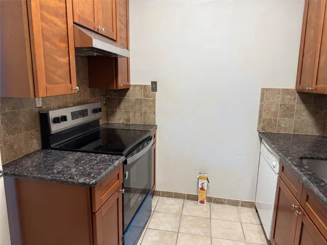 a kitchen with a refrigerator and cabinets