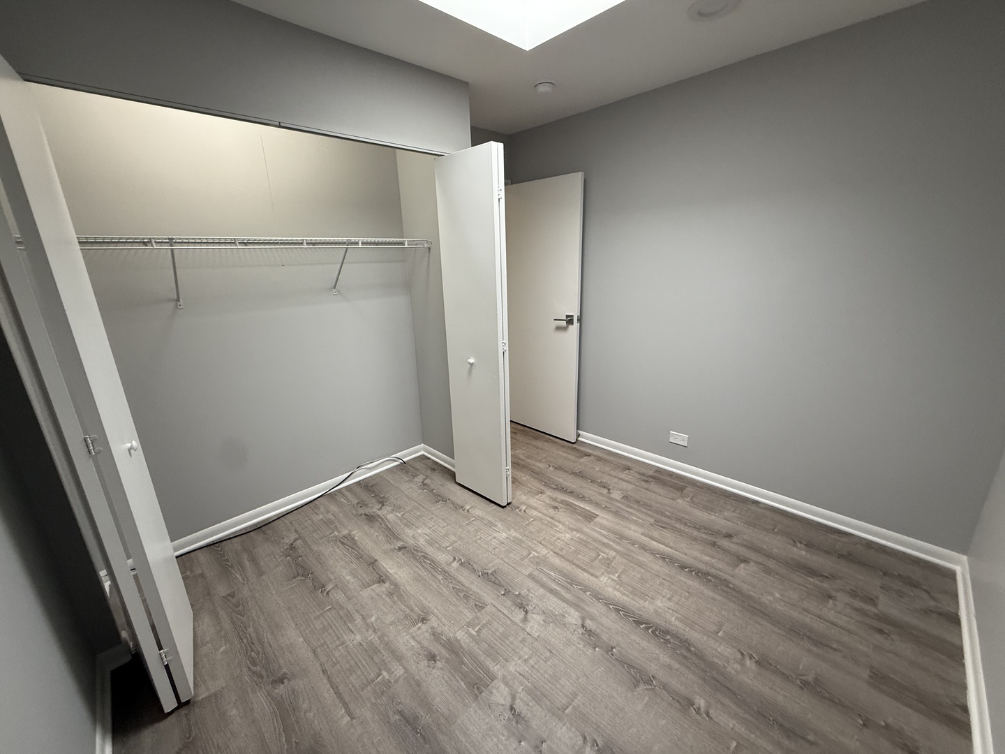 744 West Gordon Terrace, Unit 304 Chicago, IL 60613 - Photo 11 of 12 an empty room with wooden floor and entrance
