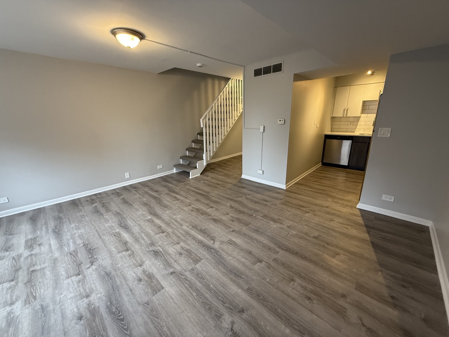 744 West Gordon Terrace, Unit 304 Chicago, IL 60613 - Photo 2 of 12 wooden floor in an empty room with a window