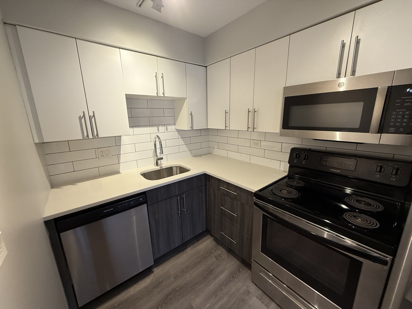 744 West Gordon Terrace, Unit 304 Chicago, IL 60613 - Photo 5 of 12 a kitchen with stainless steel appliances a stove sink and cabinets