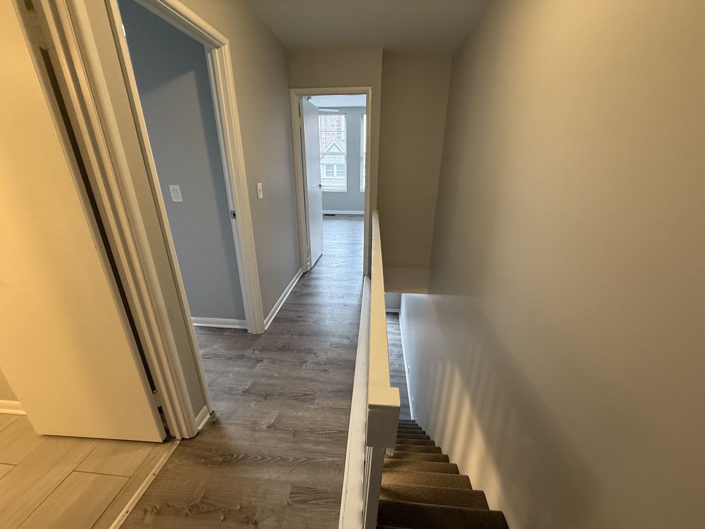 744 West Gordon Terrace, Unit 304 Chicago, IL 60613 - Photo 7 of 12 a view of a hallway with wooden floor and stairs