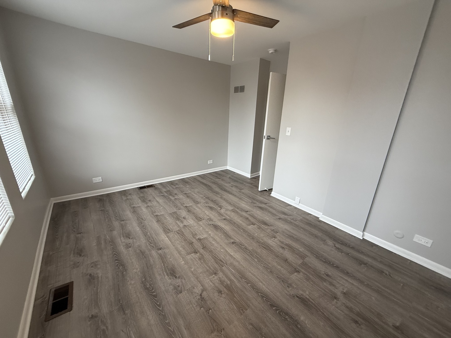 744 West Gordon Terrace, Unit 304 Chicago, IL 60613 - Photo 9 of 12 an empty room with wooden floor and fan