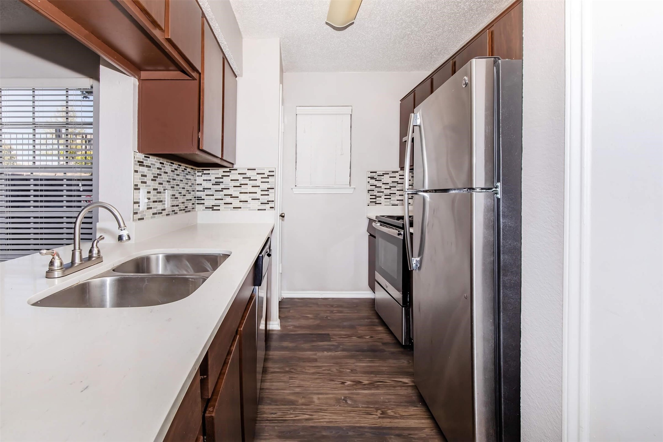 8301 Boat Club Road, Unit 1214 Fort Worth, TX 76179 - Photo 4 of 44 a kitchen with kitchen island granite countertop a sink and refrigerator