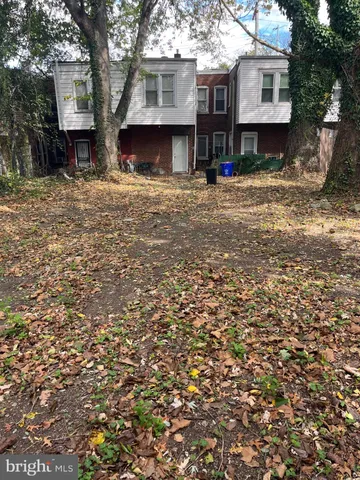 a view of a house with a tree in front of it