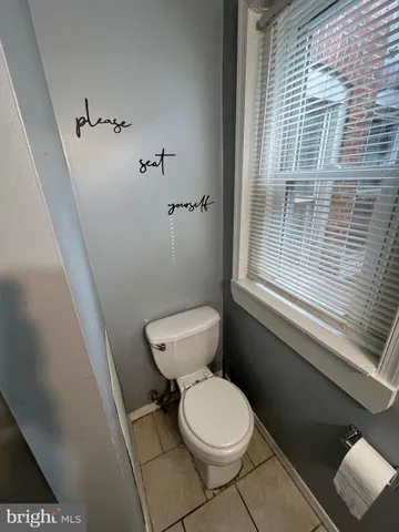 a white toilet sitting next to a window