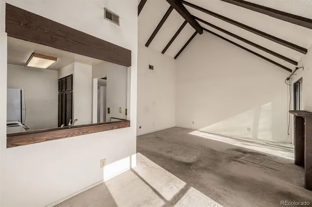 a view of an empty room with windows