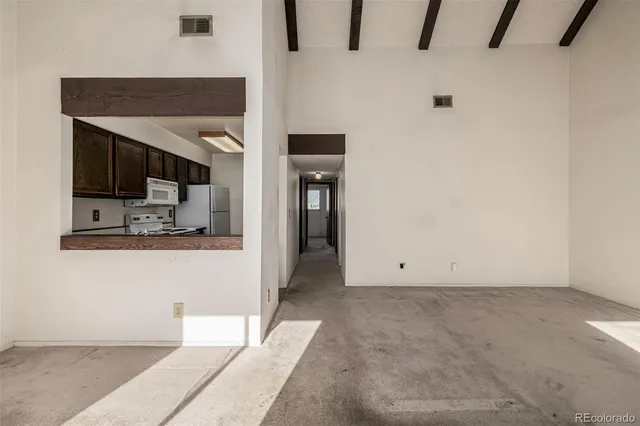 a kitchen with stainless steel appliances a stove a refrigerator and a cabinets