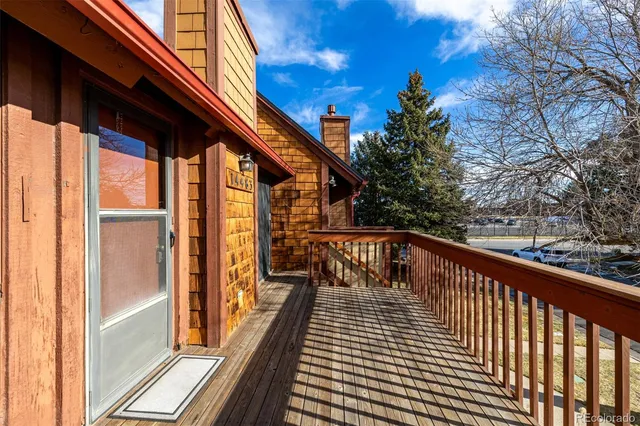 a view of balcony with wooden floor and fence