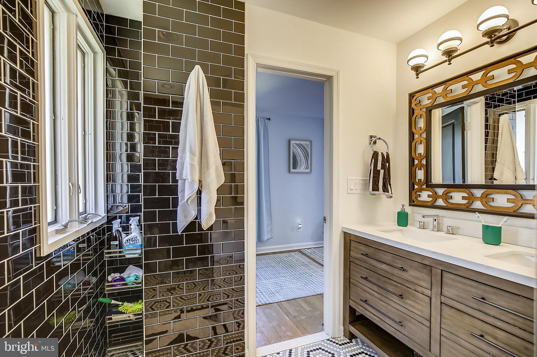 400 Stonington Road Silver Spring, MD 20902 - Photo 24 of 66 a bathroom with a double vanity sink and a mirror