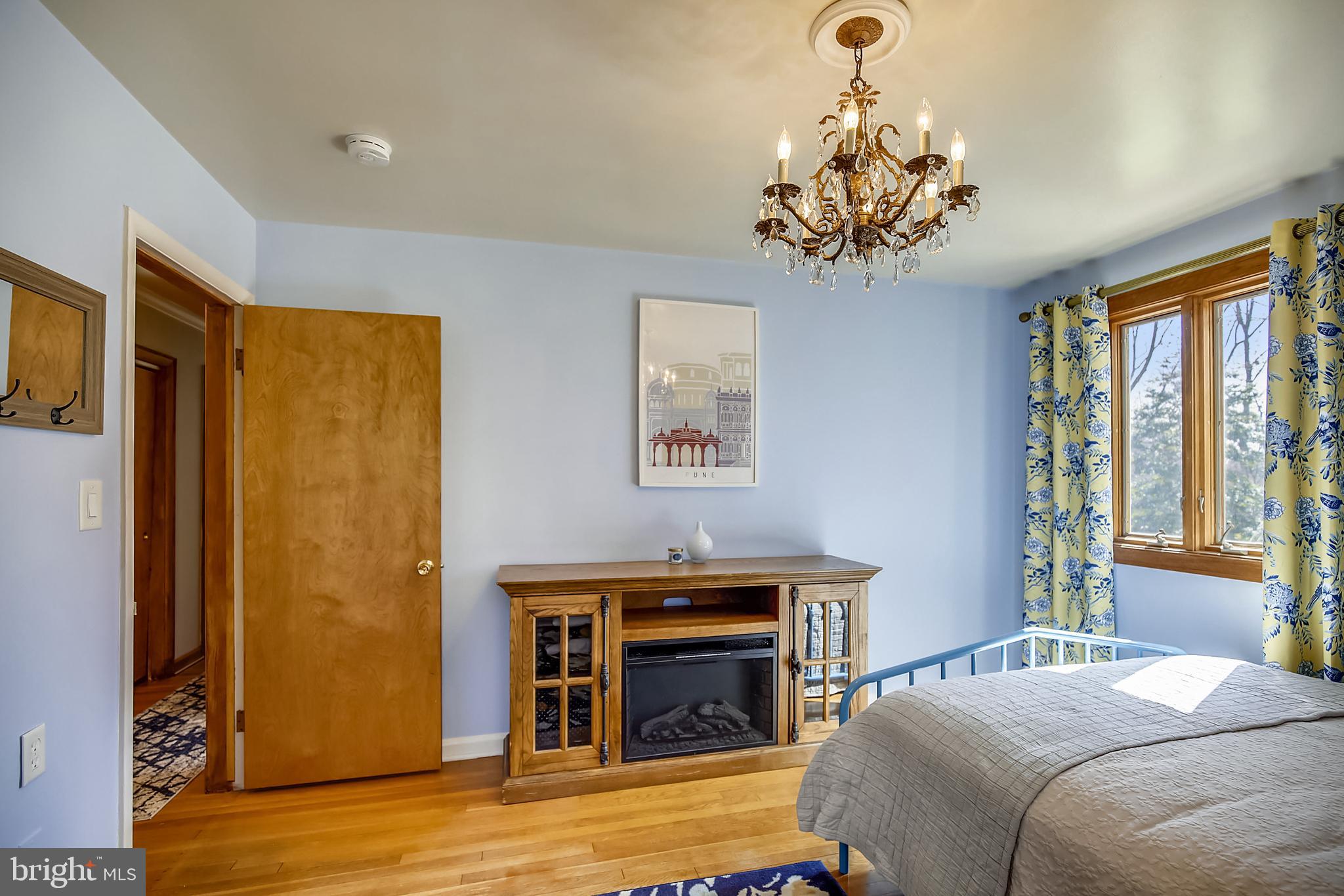 400 Stonington Road Silver Spring, MD 20902 - Photo 27 of 66 a bedroom with a bed and a chandelier