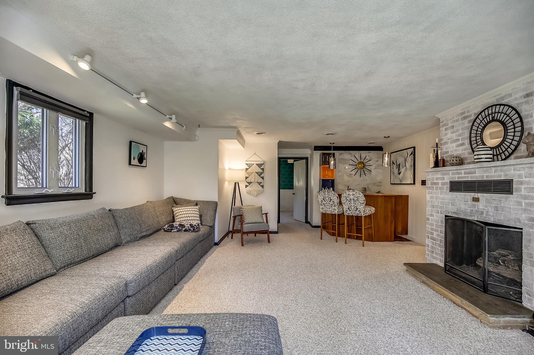 400 Stonington Road Silver Spring, MD 20902 - Photo 33 of 66 a living room with furniture and a fireplace