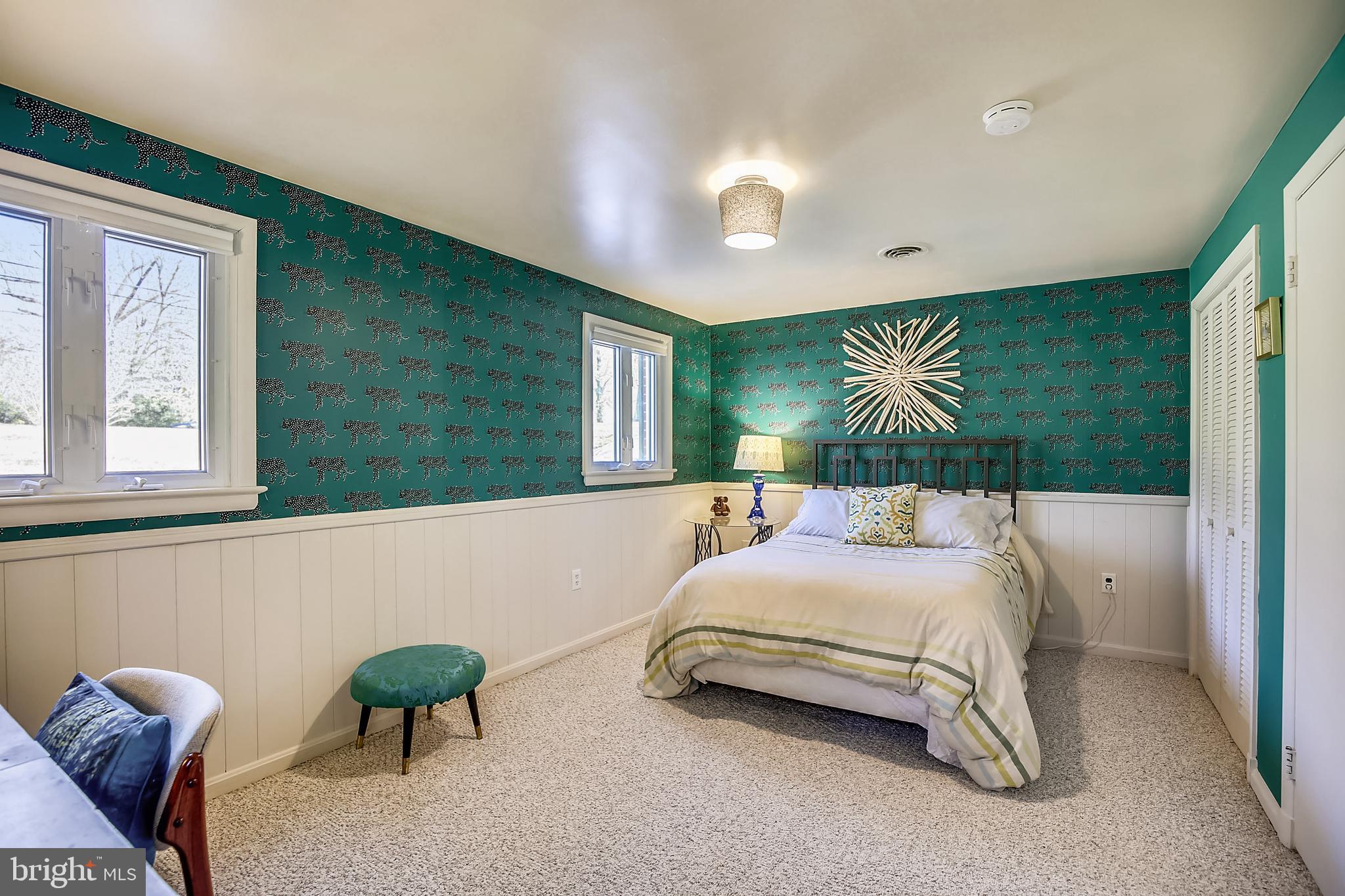 400 Stonington Road Silver Spring, MD 20902 - Photo 39 of 66 a bedroom with a bed and a chandelier