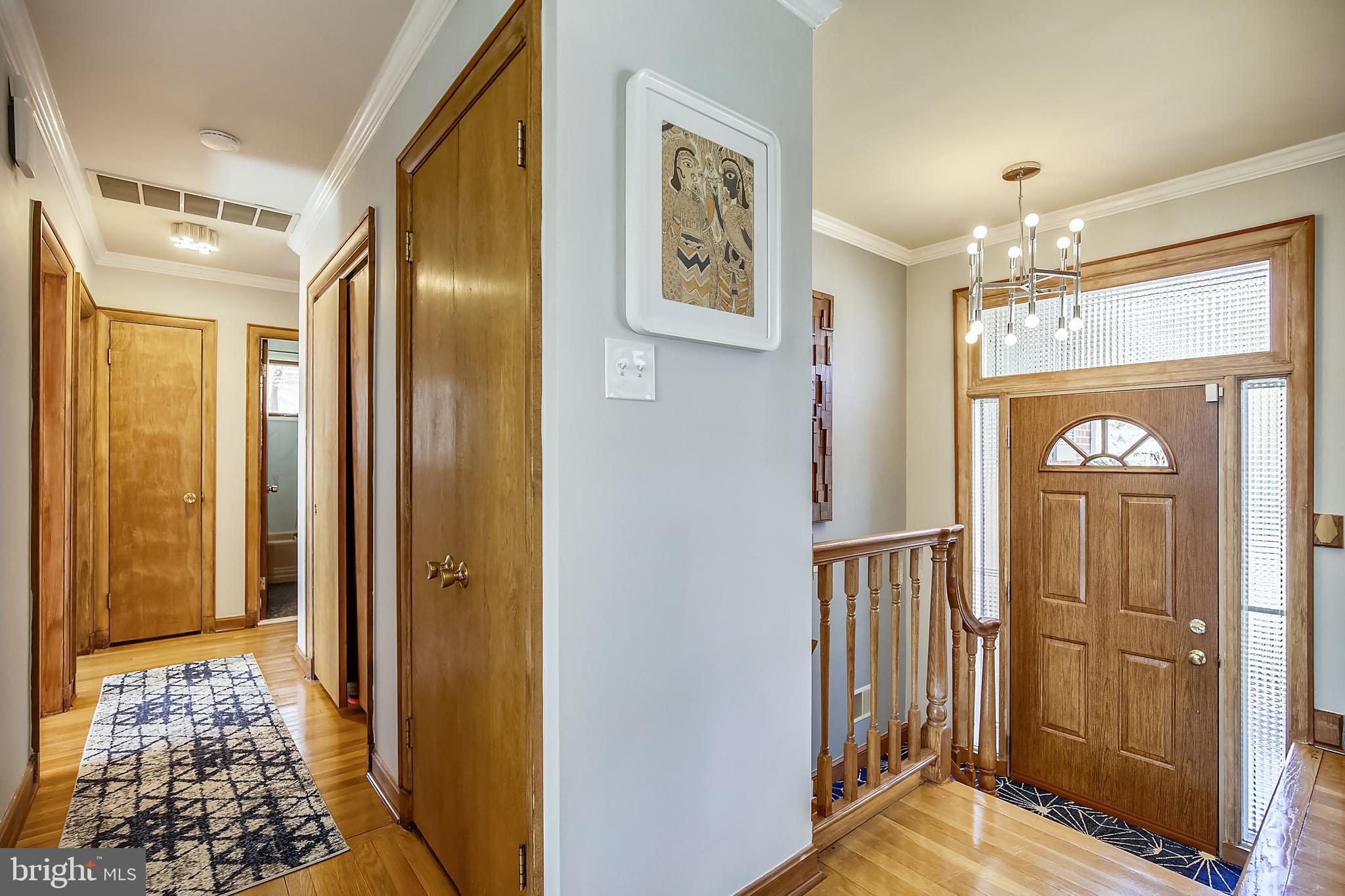400 Stonington Road Silver Spring, MD 20902 - Photo 4 of 66 a view of a hallway with wooden floor and staircase