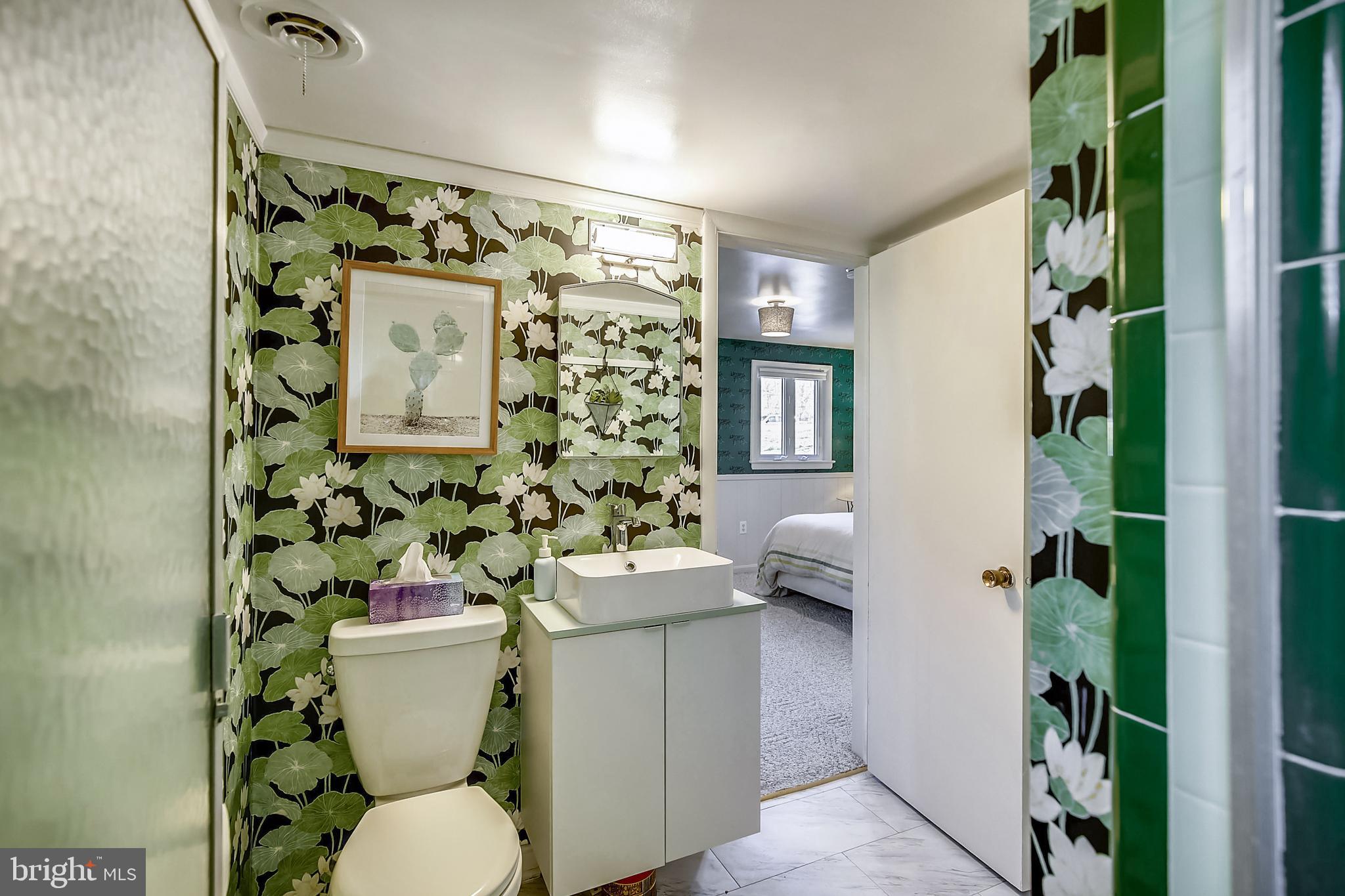 400 Stonington Road Silver Spring, MD 20902 - Photo 42 of 66 a white toilet sitting next to a bathroom sink and a shower