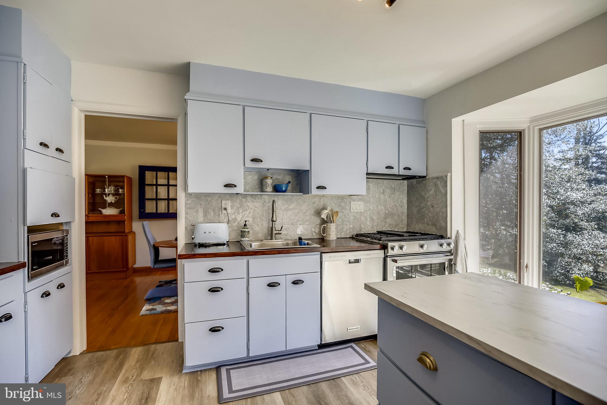 400 Stonington Road Silver Spring, MD 20902 - Photo 9 of 66 a kitchen with granite countertop a sink cabinets and stainless steel appliances