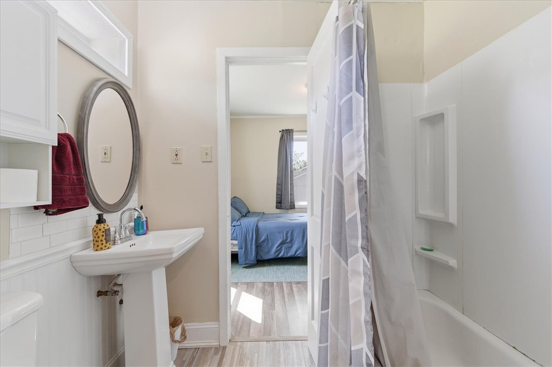 307 South Elm Street Pendleton, SC 29670 - Photo 14 of 41 This bathroom features a sleek pedestal sink and a clean, functional tub.