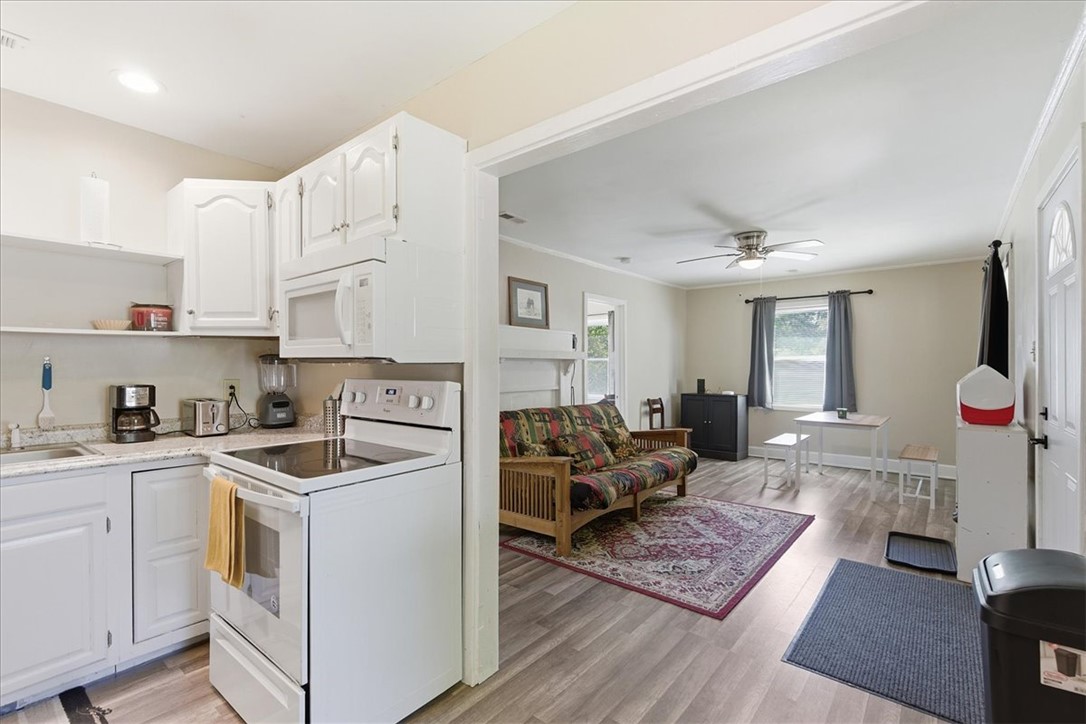 307 South Elm Street Pendleton, SC 29670 - Photo 19 of 41 This inviting space combines practical kitchen amenities with a comfortable living area, perfect for daily life.