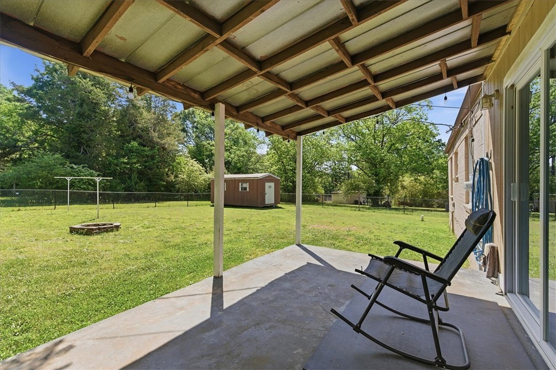 307 South Elm Street Pendleton, SC 29670 - Photo 30 of 41 This tranquil backyard offers a covered patio and a spacious lawn, perfect for outdoor enjoyment.