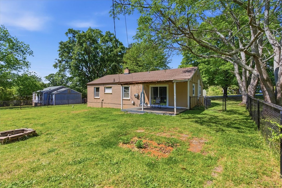 307 South Elm Street Pendleton, SC 29670 - Photo 35 of 41 This residence features a fenced backyard, a patio, and a well-maintained lawn.