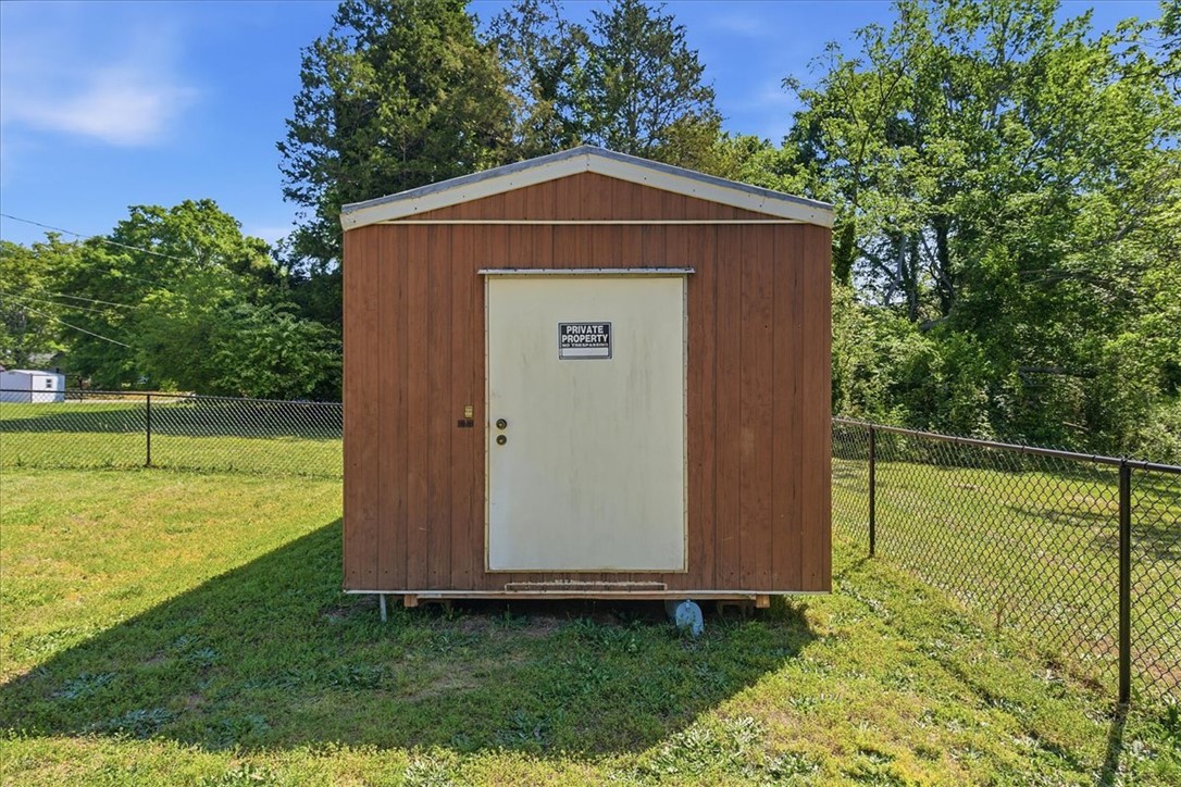 307 South Elm Street Pendleton, SC 29670 - Photo 37 of 41 This property features a functional storage shed on a grassy lot.
