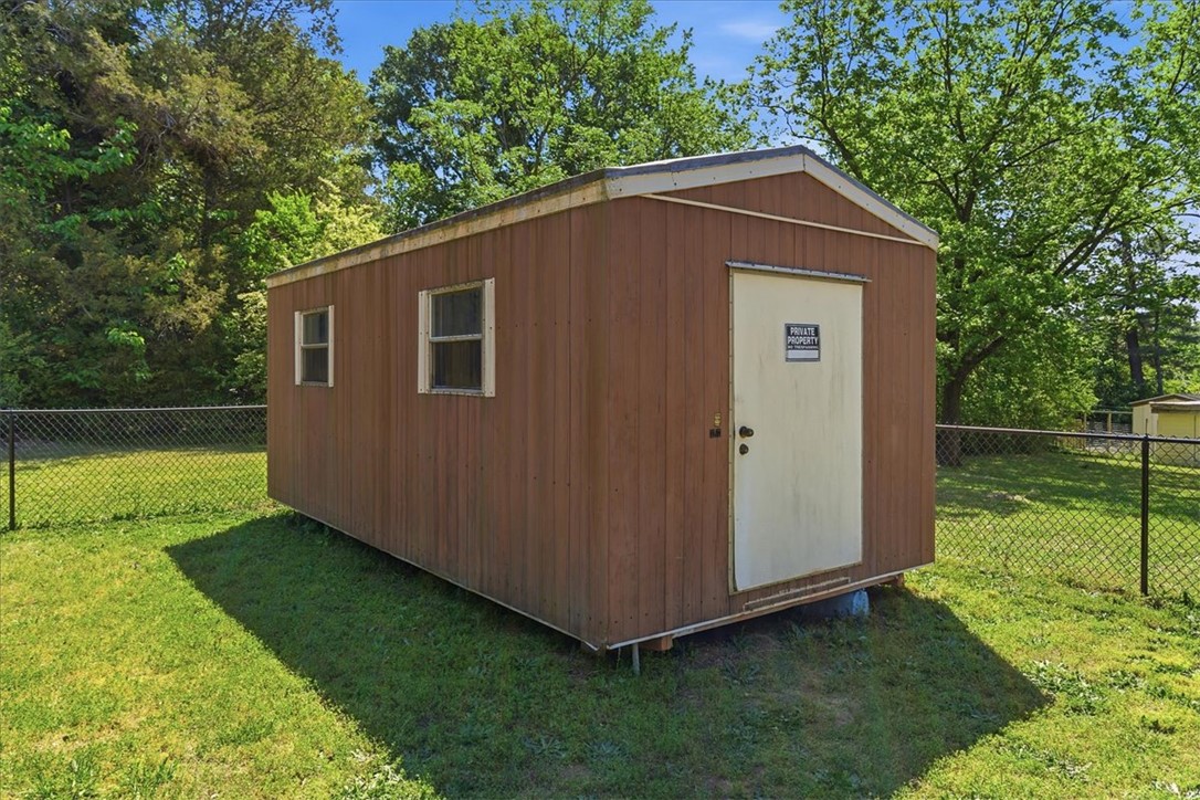 307 South Elm Street Pendleton, SC 29670 - Photo 38 of 41 This charming utility shed offers practical storage amidst a lush, green yard.