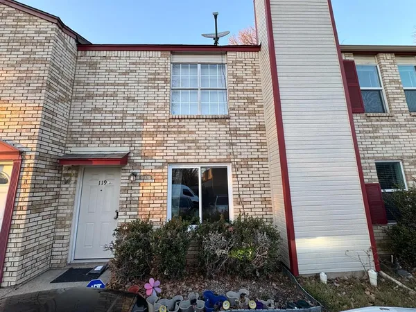 a front view of a house with plants