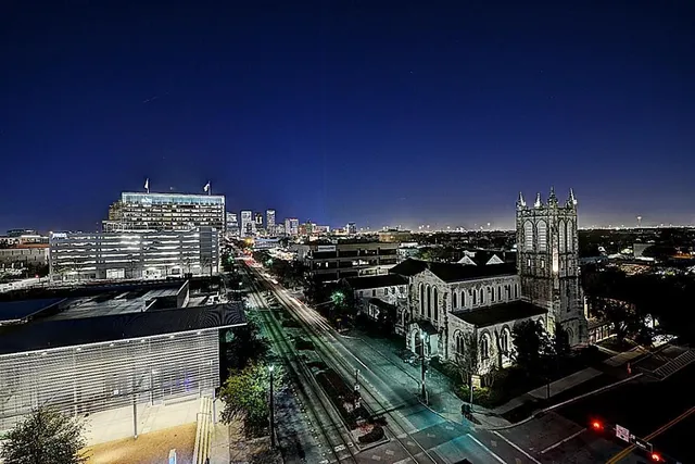 a front view of a building with play ground and trees in the background