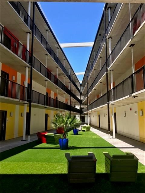 3550 Main Street, Unit 4215 Houston, TX 77002 - Photo 15 of 49 a front view of a building with play ground and trees in the background