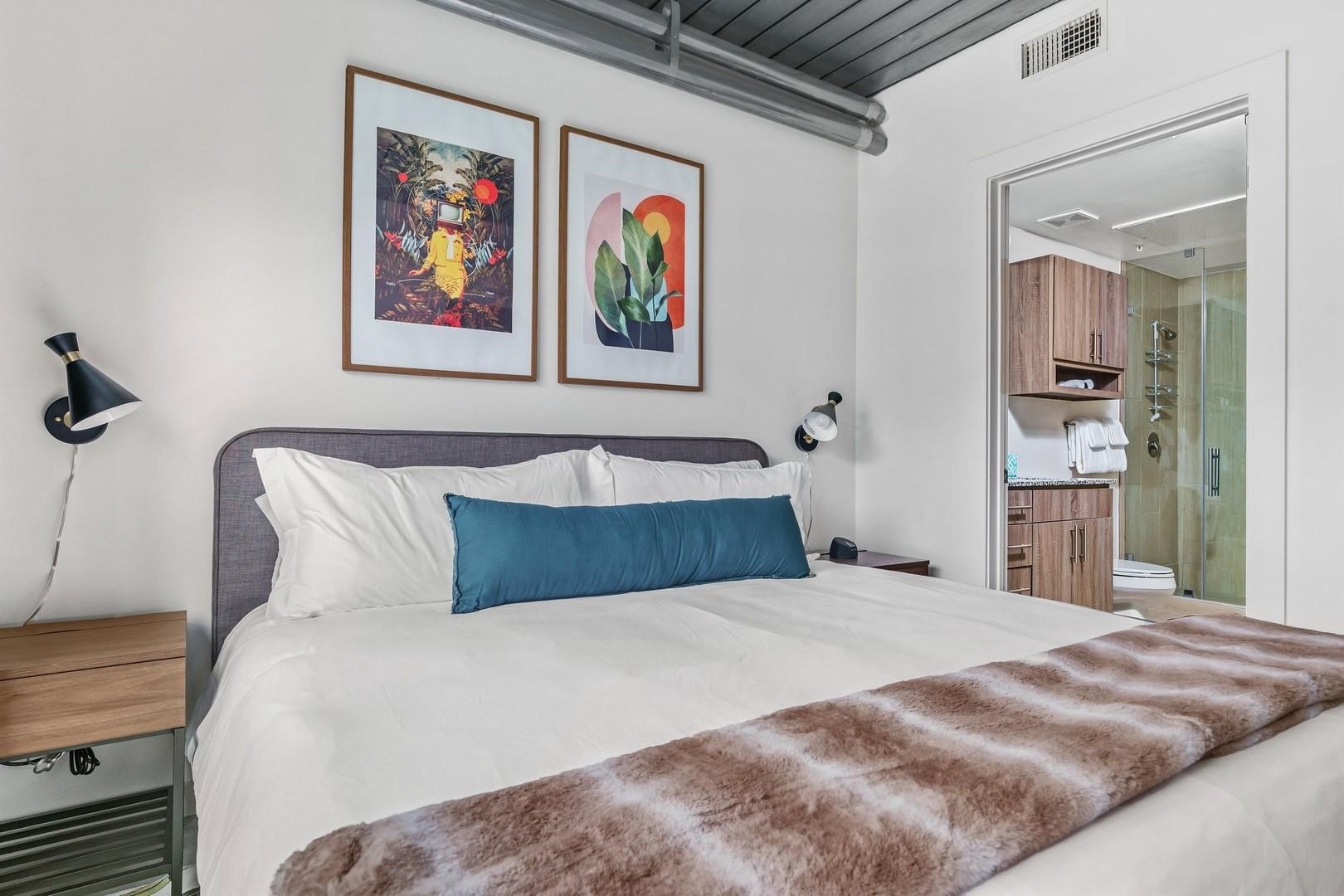 3550 Main Street, Unit 4215 Houston, TX 77002 - Photo 6 of 49 a bedroom with a bed and painting on the wall