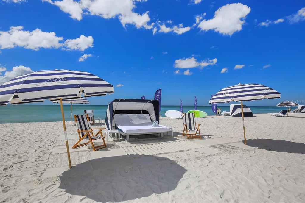 240 Sands Point Road, Unit 4104 Longboat Key, FL 34228 - Photo 33 of 47 a swimming pool with a table and chairs