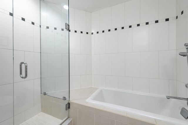 a bathroom with a bathtub and a shower