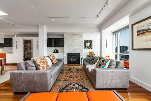 a living room with fireplace furniture and a flat screen tv
