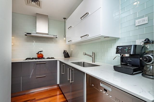 a kitchen with a sink and cabinets