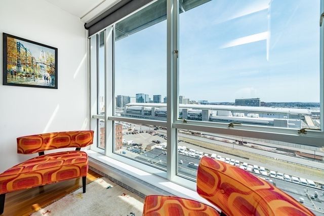 a living room with blue lights with furniture