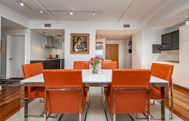 a view of a dining room with furniture and a potted plant