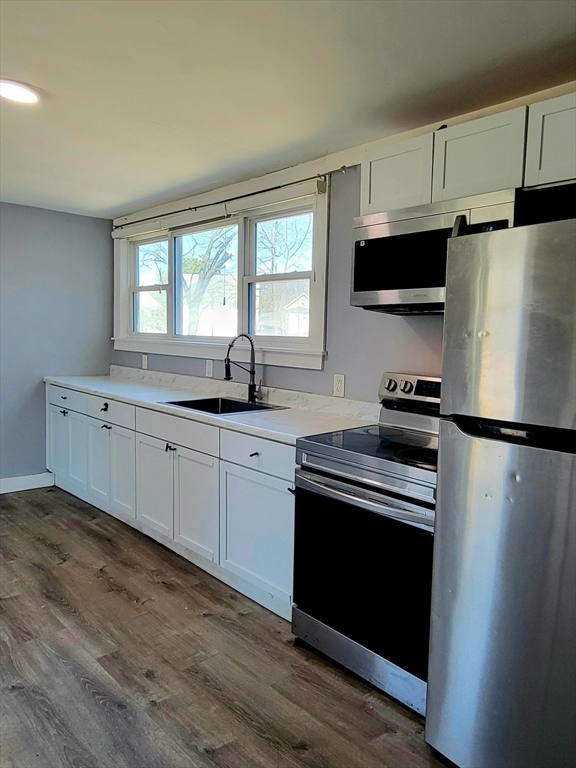 136 Commonwealth Road Wayland, MA 01778 - Photo 25 of 27 a kitchen with a refrigerator sink and cabinets