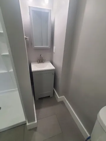 a view of bathroom with a sink and mirror
