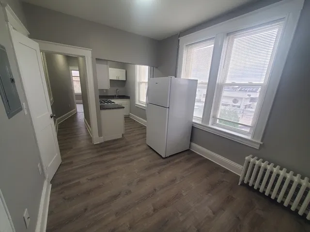 a view of kitchen with furniture and wooden floor