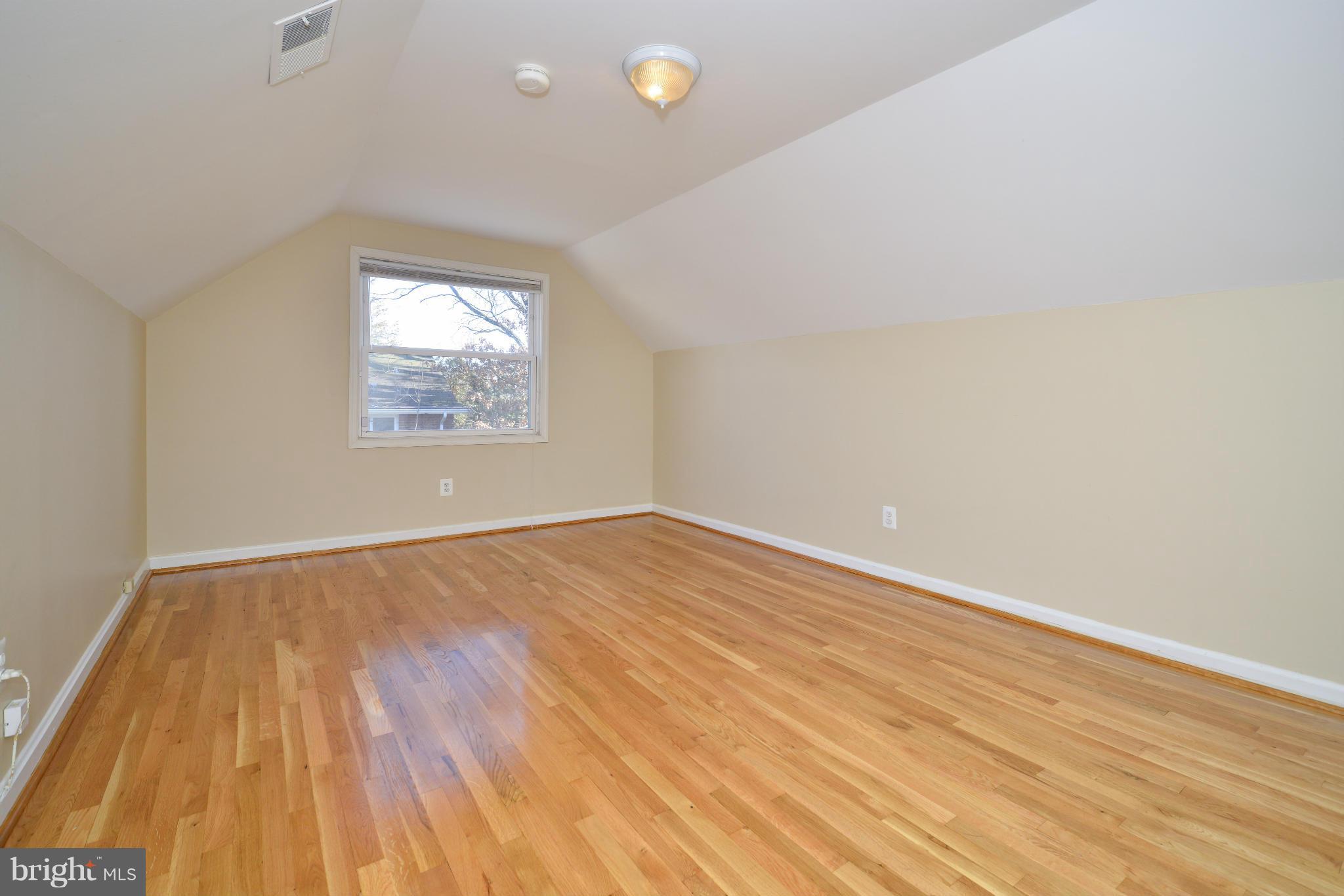 6902 Highland Street Springfield, VA 22150 - Photo 13 of 24 an empty room with wooden floor and windows