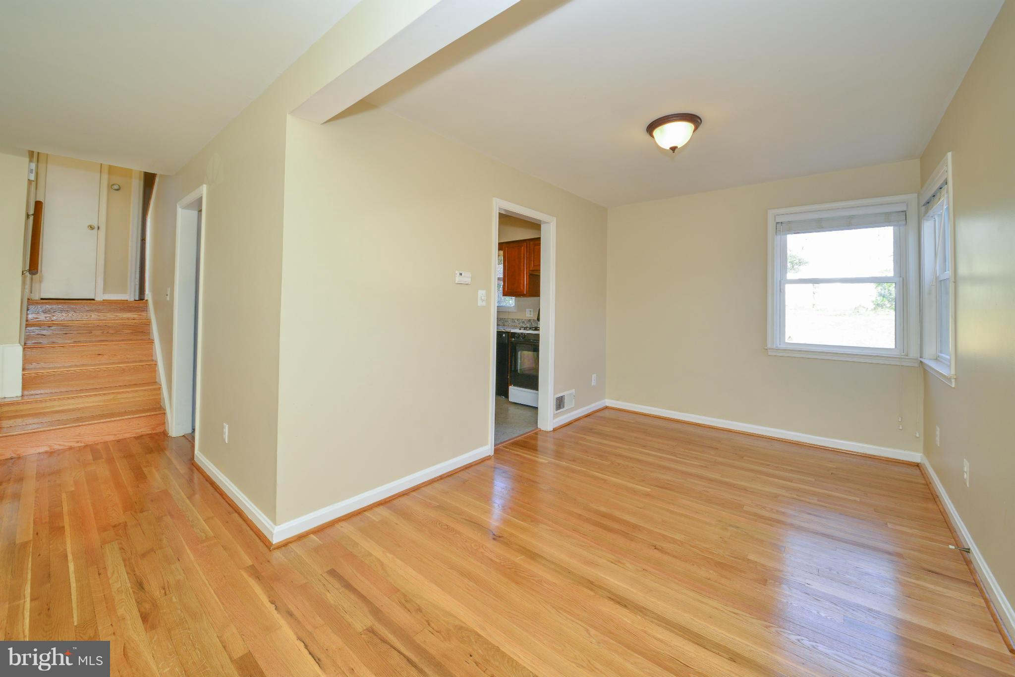 6902 Highland Street Springfield, VA 22150 - Photo 7 of 24 a view of empty room with wooden floor and fan