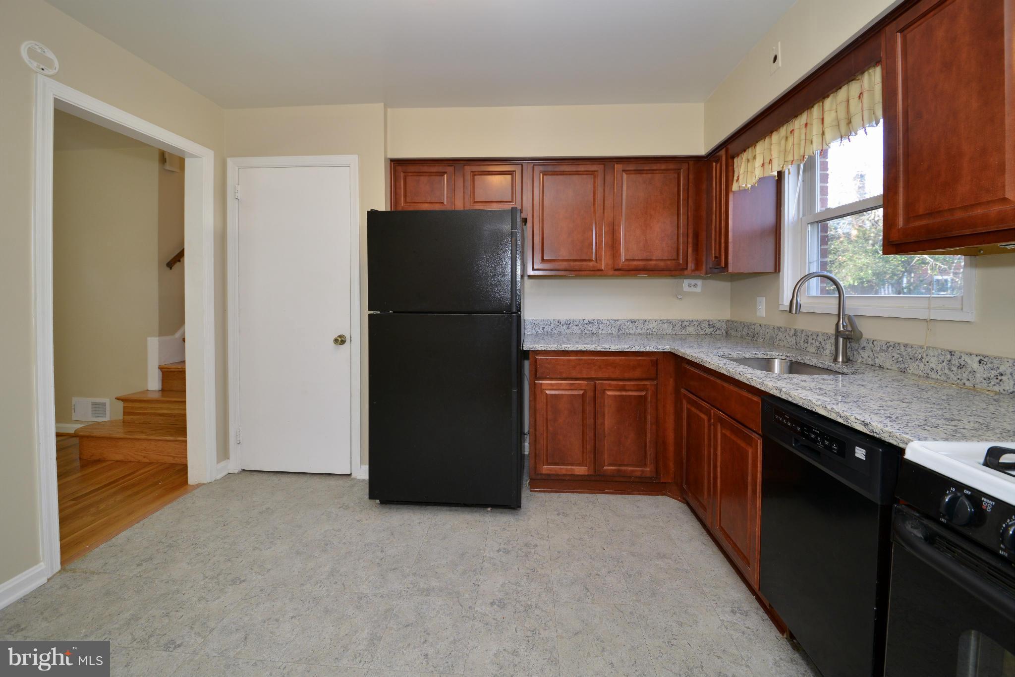 6902 Highland Street Springfield, VA 22150 - Photo 9 of 24 a kitchen with a refrigerator sink and cabinets