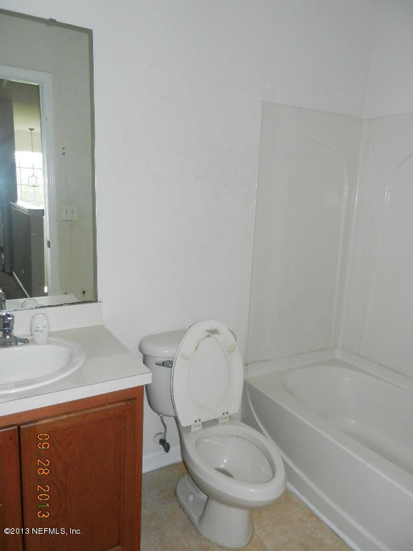 7278 Rampart Ridge Circle South Jacksonville, FL 32244 - Photo 11 of 14 a bathroom with a granite countertop toilet sink and mirror