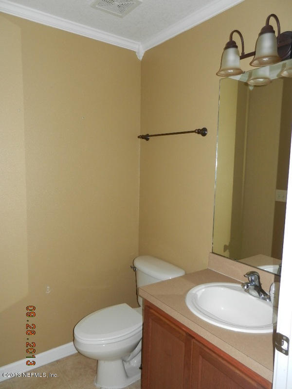 7278 Rampart Ridge Circle South Jacksonville, FL 32244 - Photo 12 of 14 a bathroom with a granite countertop sink and a mirror