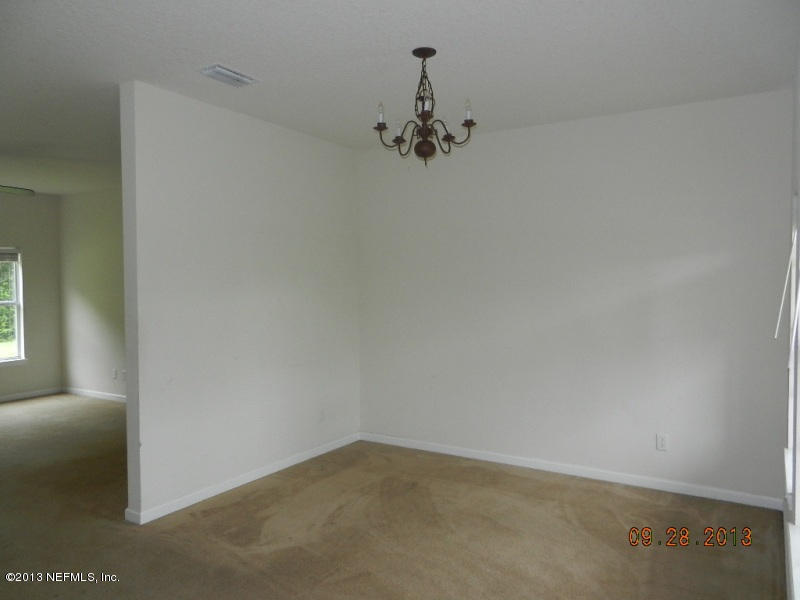 7278 Rampart Ridge Circle South Jacksonville, FL 32244 - Photo 2 of 14 an empty room with a chandelier fan