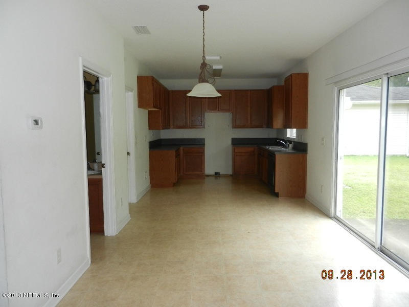 7278 Rampart Ridge Circle South Jacksonville, FL 32244 - Photo 5 of 14 a dining room with a chandelier