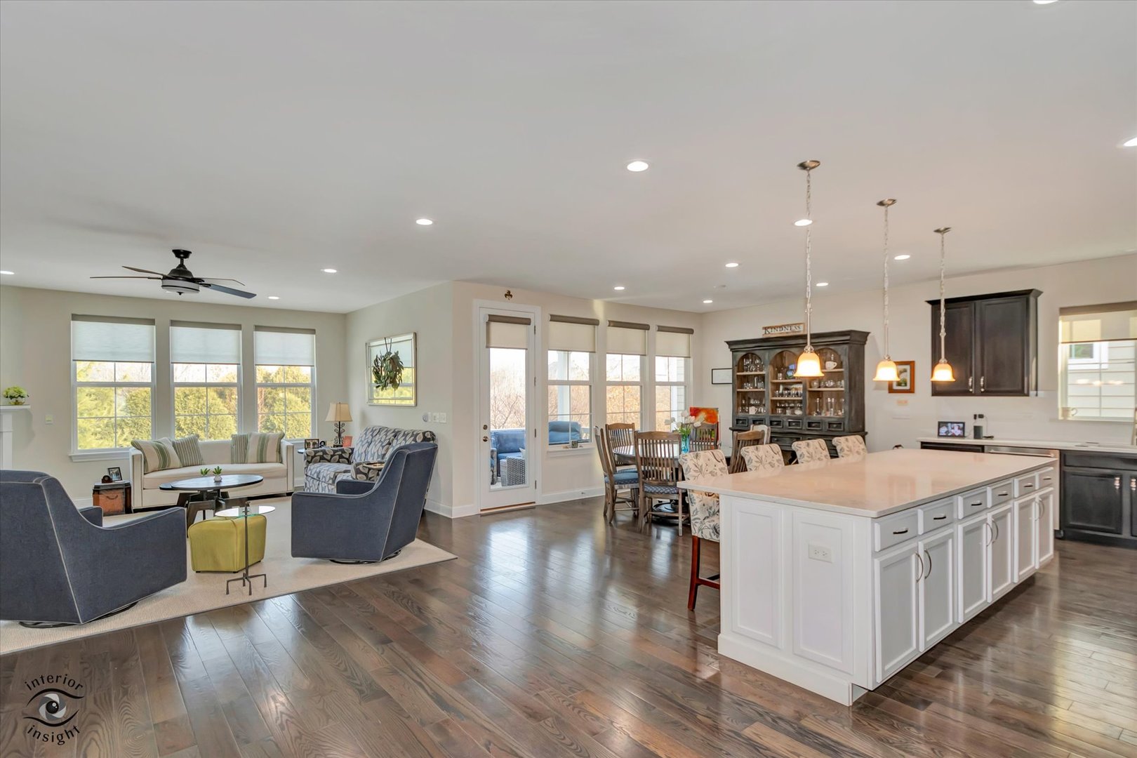 318 Arabian Circle Willowbrook, IL 60527 - Photo 8 of 37 a large living room with stainless steel appliances kitchen island granite countertop a large kitchen island a stove a sink a dining table and chairs with wooden floor