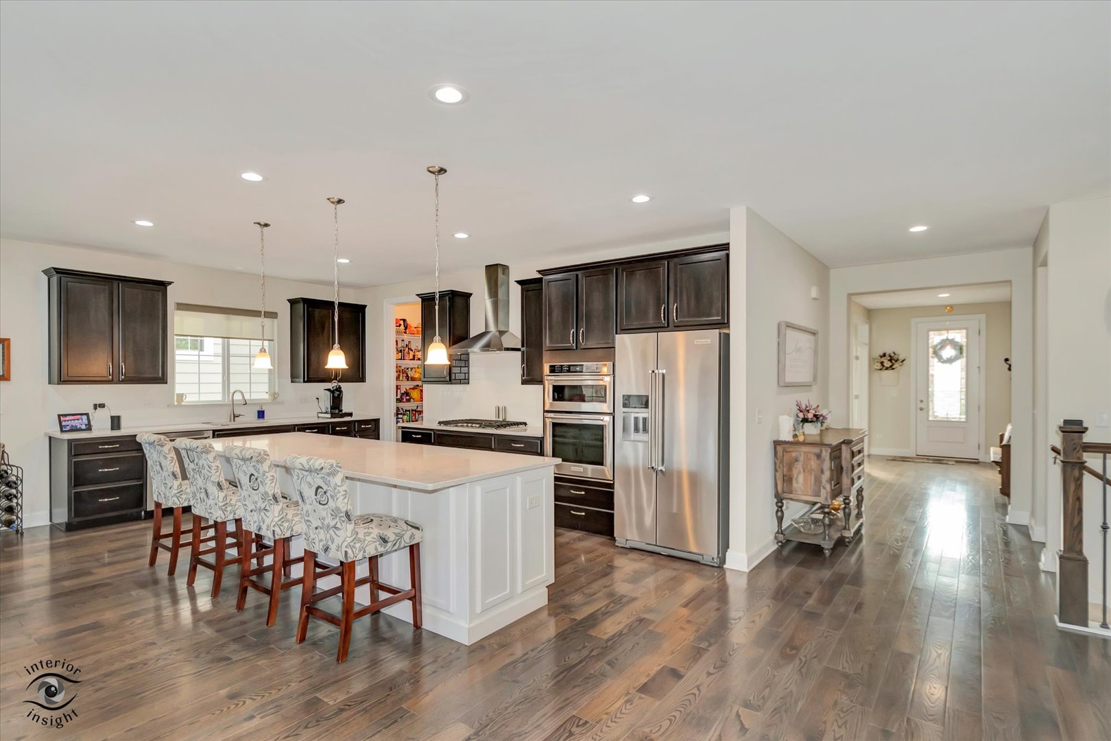 318 Arabian Circle Willowbrook, IL 60527 - Photo 9 of 37 a large kitchen with dining table chairs and refrigerator