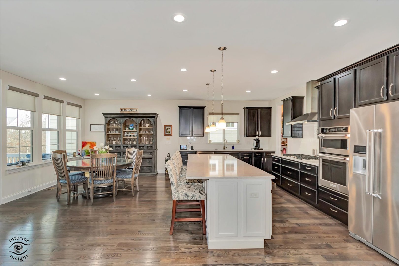 318 Arabian Circle Willowbrook, IL 60527 - Photo 10 of 37 a large kitchen with stainless steel appliances granite countertop a stove top oven a table and chairs
