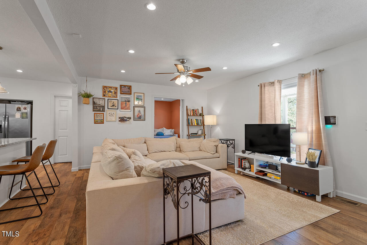 2220 Foxtrot Road Raleigh, NC 27610 - Photo 11 of 24 a living room with furniture and a flat screen tv